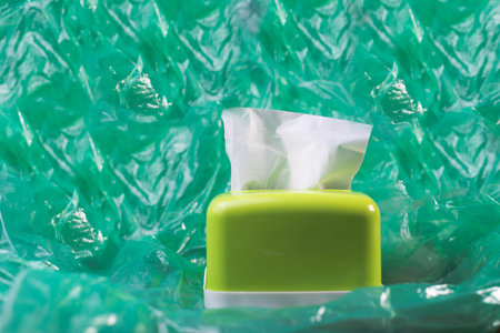 tissue in a green tissue box green backgroundの写真素材
