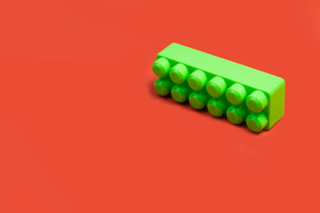 green building block on orange backgroundの写真素材