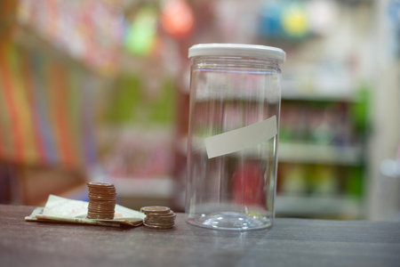 The piggy bank is empty. There is a sticker for writing a message. Next to the piggy bank are coins...