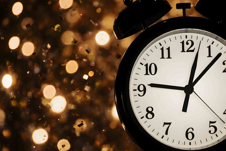 A captivating and festive image of a classic grandfather clock, with a glowing light flare emanating from its face, marking the final moments before midnight. The clock's hands are nearing the top, symbolizing the start of a new year. In the background, a cascade of sparkling confetti falls against a soft-focus backdrop of colorful bokeh lights, creating a celebratory and magical atmosphere. This image perfectly captures the excitement, hope, and anticipation of New Year's Eve, ideal for holiday promotions, greeting cards, and seasonal designs.の素材