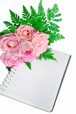 Bouquet of roses and a diary on white backgroundの写真素材