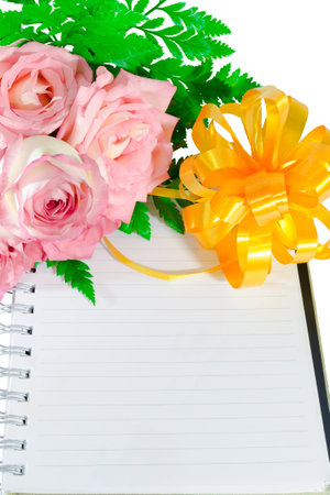 roses ribbon and a diary on  white backgroundの写真素材