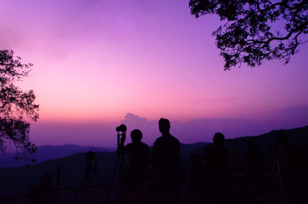 traveler and tree silhouette on sunset at viewpoint Pui chiangmai thailand,soft focus styleの写真素材