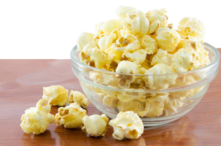 Glass bowl with popcorn on wood backgroundの写真素材