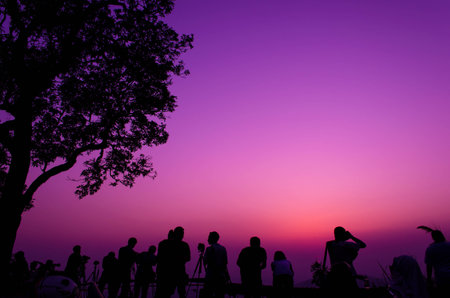 traveler and tree silhouette on sunset at viewpoint Pui chiangmai thailandの写真素材