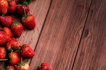 Strawberries on wooden background. Top view with copy space.の写真素材