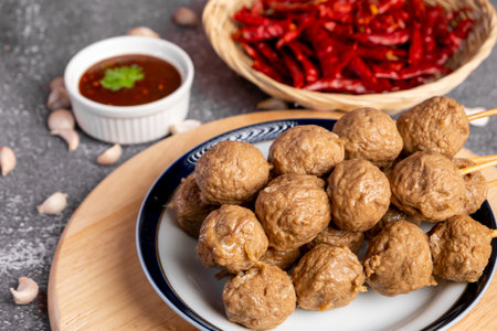 Meatballs with sweet chili sauce and garlic on a gray background.の写真素材