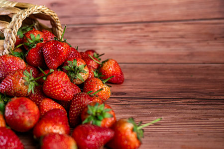 Strawberries in a basket on a wooden background. Toned.の写真素材