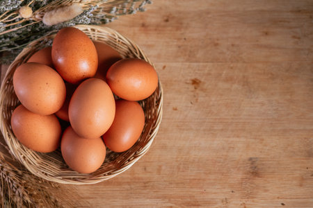 Easter eggs in a basket on a wooden background. Copy space.の写真素材