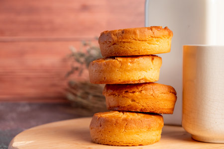 Stack of cookies and glass of milk on wooden background. Close upの写真素材