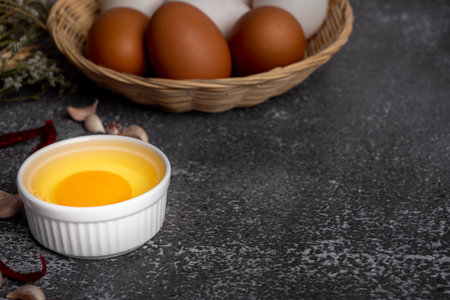 Raw eggs in a basket on a black background. Selective focus.の写真素材