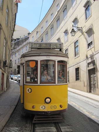 Ancient tram in narrow street of Lisbon.のeditorial素材