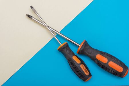 Home improvement: two screwdrivers on a blue and white flat lay background with copy space.の写真素材