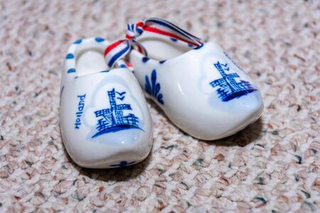 Delft Blue Figurine of dutch wooden shoes porcelain. Souvenir from Holland/Netherlands. Isolated on...