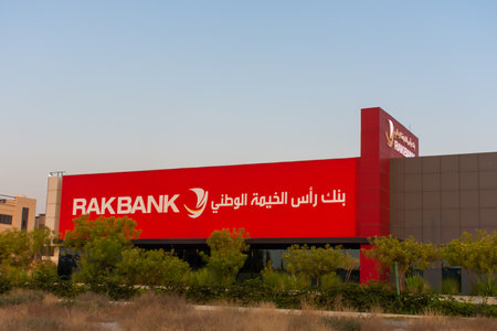 "Ras al Khaimah, RAK/ United Arab Emirates - 6/26/2019: RAK Bank red sign in evening on a main road in the northern Emriates"のeditorial素材