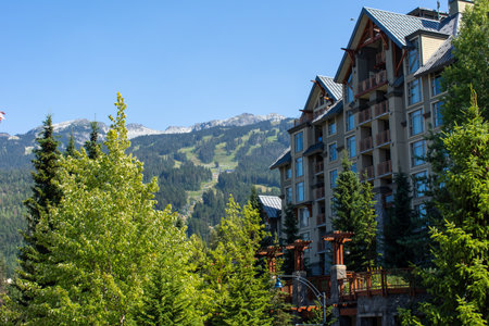Whistler Mountain in British Columbia, Canada looking to the summer ski lifts and Gondola at Blackcomb and the village accommodations on a sunny day.のeditorial素材