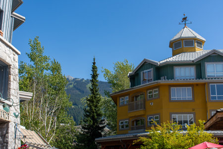 Whistler Mountain in British Columbia, Canada looking to the summer ski lifts and Gondola at Blackcomb and the village accommodations on a sunny day.のeditorial素材
