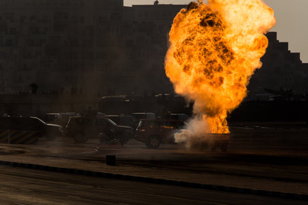 Military strike or bomb on a car in war causes fire ball and explosion amid chaos. Military concept. Strength, power, force, fire, explosion.のeditorial素材