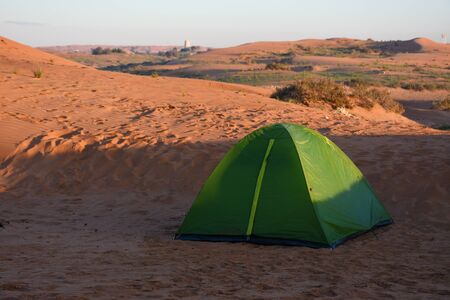 A green tent for family camping in the sand dunes of the United Arab Emirates desert. Family fun, isolated, quiet, arid.の写真素材