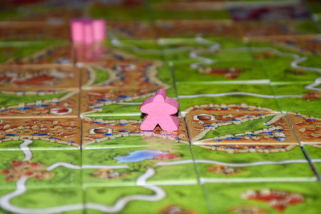 "RAK, RAK/UAE - 1/1/2020: Family fun card building game of Carcassonne game showing a hand building cities, roads and farms."のeditorial素材