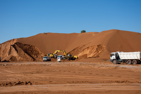 "Ras al Khaimah, RAK/UAE - 1/12/2020: Construction excavation crew of bulldozers, dump trucks, and backhoes dig out the sand for road maintenance in the Middle East"のeditorial素材