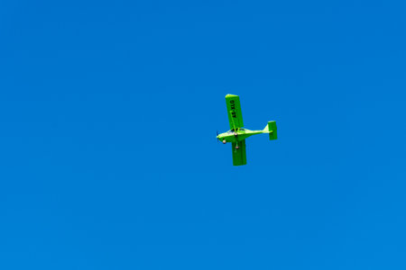Small green private plan on bright blue summer sky for aerial views and tourist attractions.のeditorial素材