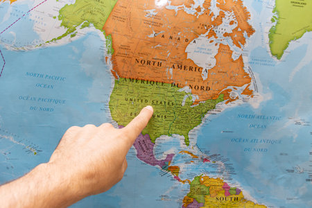 "RAK, RAK/UAE - 4/12/2020: Finger pointing to a colorful country map in English and French of  United States of America. "のeditorial素材