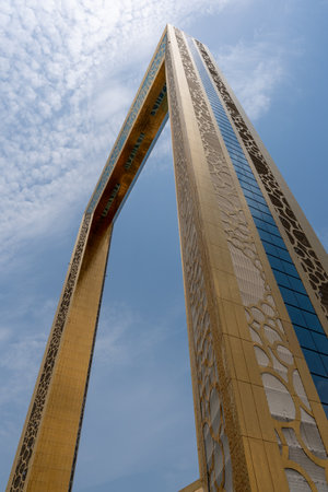 "Dubai, United Arab Emirates - 8/11/2020: The Dubai Frame modern architecture in downtown golden color on a blue sky sunny day. Portrait looking up"のeditorial素材