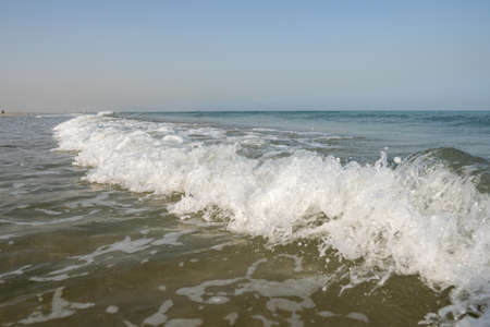 Crashing white waves and blue water and sky from the ocean or sea in the tropical warm holiday...
