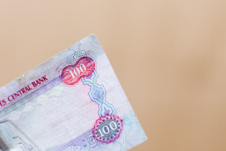 The Currency of the United Arab Emirates (UAE) - Close up of a red one hundred Dirham note  on a...