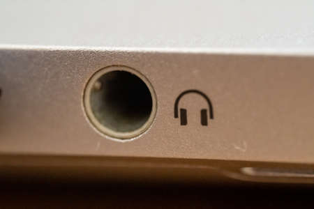 Computer audio port very close up on a silver computer for audio, speaker and computer conceptsの写真素材