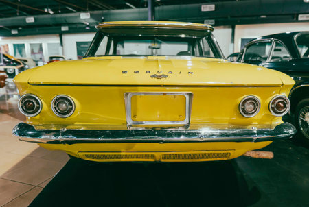 "7/31/2021 - Sharjah, UAE: 1960s Back view of Corvair an American classic bright yellow car by Chevroletのeditorial素材