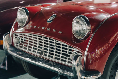 "7/31/2021 - Sharjah, UAE:  Classic British Triumph Car - bright red front bumper with chrome.のeditorial素材