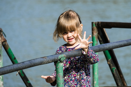 Little girl shows five fingersの写真素材