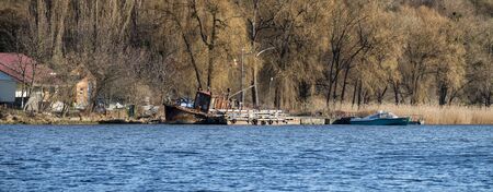 Old rusty rickety boat on the bank of the Southern bug river. Rescue stationの写真素材