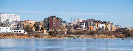 City landscape. Panoramic shot from the frozen river on the banks of which new multi-storey buildings have been erectedのeditorial素材