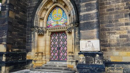 The picture shows the colorful door and a sign right next to it. It belongs to the Cathedral of St. Paul and St. Peter in the south of Prague.のeditorial素材
