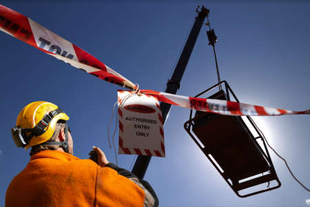 Safety work practice red and white warning danger tag tape sign applying on exclusion dropped zone...