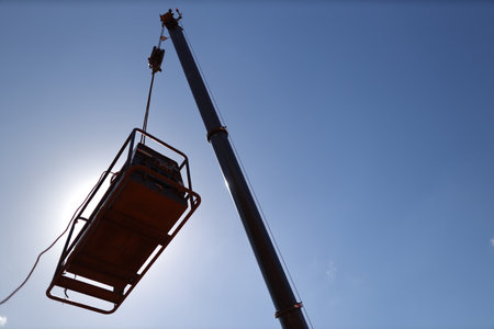 Crane driver carry out work on the opening field by moving the boom up to control the load at construction site, Sydneyの写真素材