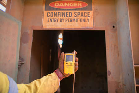 Constructor worker hand holding gas test leak detector device while commencing safety gas testing...