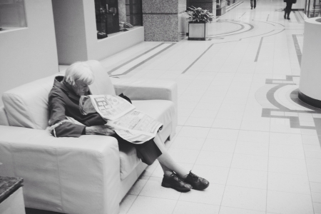 Old lady reading newspaperの素材