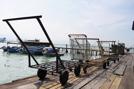 Old rusty fishermen trolley at seaside