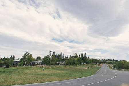 Lake Tekapo in New Zealand with cloudy sky and blue lake