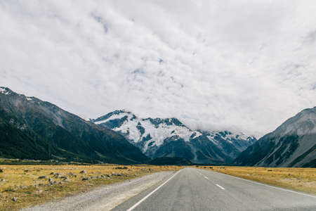 Beautiful blue cloudy sky with lake and mountain rockの写真素材