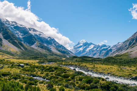 Beautiful blue cloudy sky with lake and mountain rockの写真素材