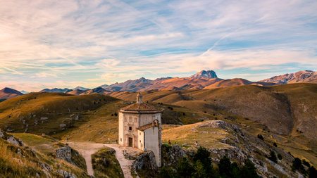 The rolling hills of the Apennines mountain range as seen from Rocca Calascio, featuring Santa Maria della PietÃ .の写真素材
