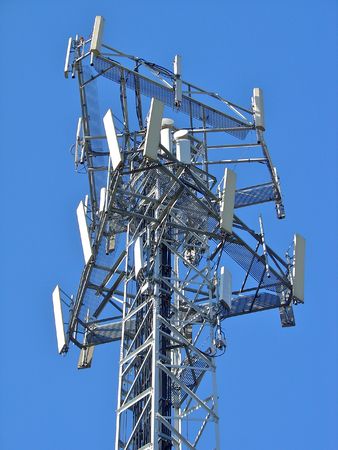 Mobile comunications antenna, for 2G (GSM) and 3G (UMTS/WCDMA) handsets in Europe. Antennas for 3 carriers share the same mast.の写真素材