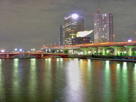 Sumidagawa River at night in Asakusa district in Tokyo, Japan. The thing over the building is supposed to be beer lupulus, and is a popular spot for people living there.の写真素材