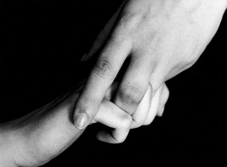 One hand takes other as if helping in a bad moment, showing one of the warm sides of a person's most human body parts, the hands.の写真素材