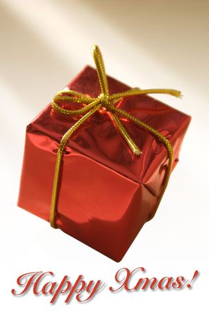 Presents wrapped in a shiny red paper with a cute golden lace.の写真素材
